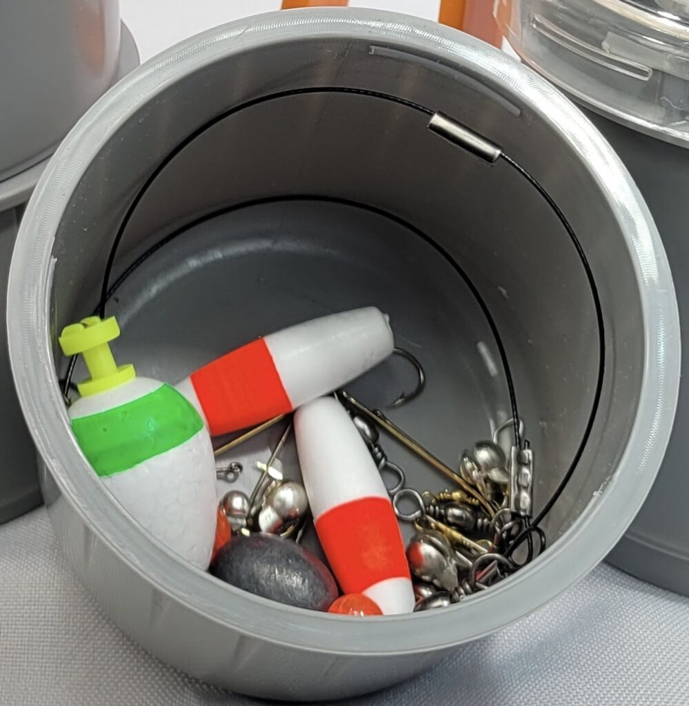 Quick Baiter storage compartment with fishing bobbers, weights, and tackle accessories
